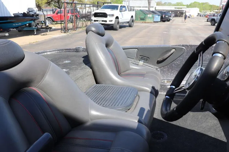 Slide: The Image of 2011 Ranger 518 boat interior with gray seats and steering wheel. - 26