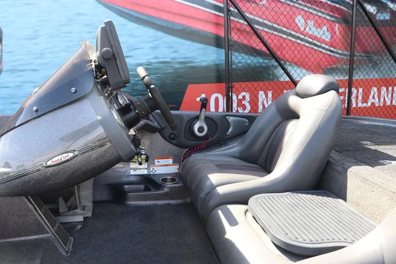 Slide: The Image of 2011 Ranger 518 boat interior with steering wheel and seating, displayed at a boat show. - 27