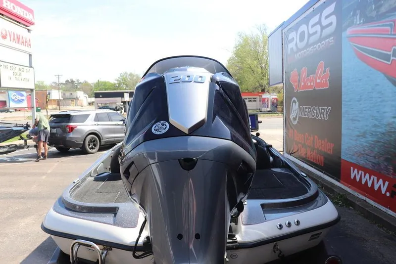 Slide: The Image of 2011 Ranger 518 boat with powerful engine, parked near dealership signs. - 4