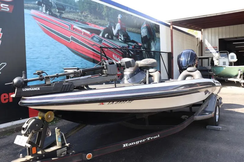 Slide: The Image of 2011 Ranger 518 boat with Lowrance equipment on trailer, parked outside a marine shop. - 5