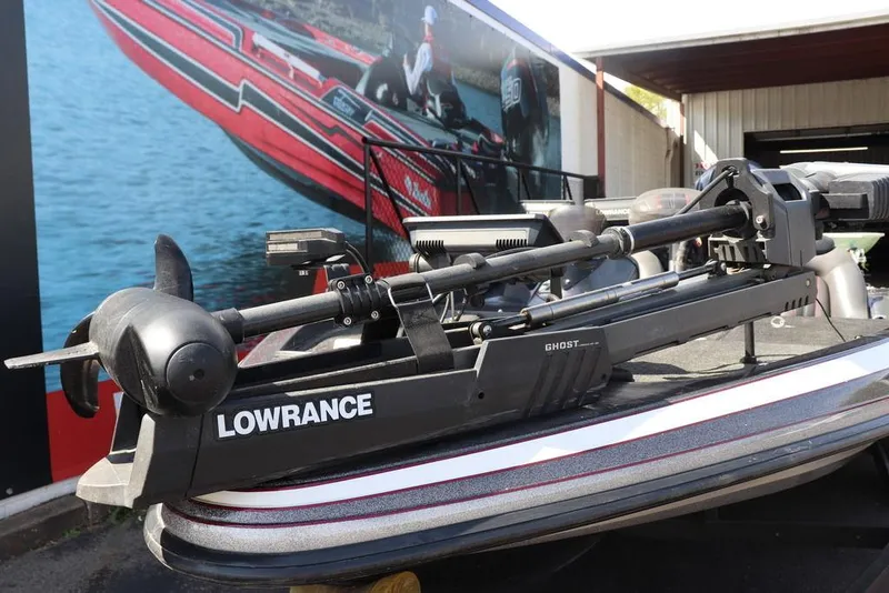 Slide: The Image of 2011 Ranger 518 boat with Lowrance Ghost trolling motor, parked near a mural. - 6