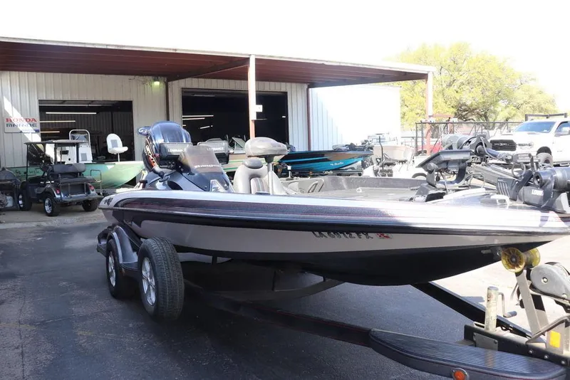 Slide: The Image of 2011 Ranger 518 boat on trailer outside a marine shop. - 8
