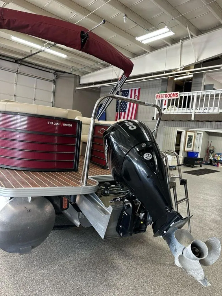 Slide: The Image of 2018 Crest Classic 230 SLC pontoon boat with outboard motor in showroom. - 14