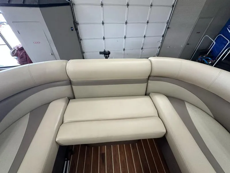 Slide: The Image of 2018 Crest Classic 230 SLC boat interior with beige seating and wood flooring. - 5