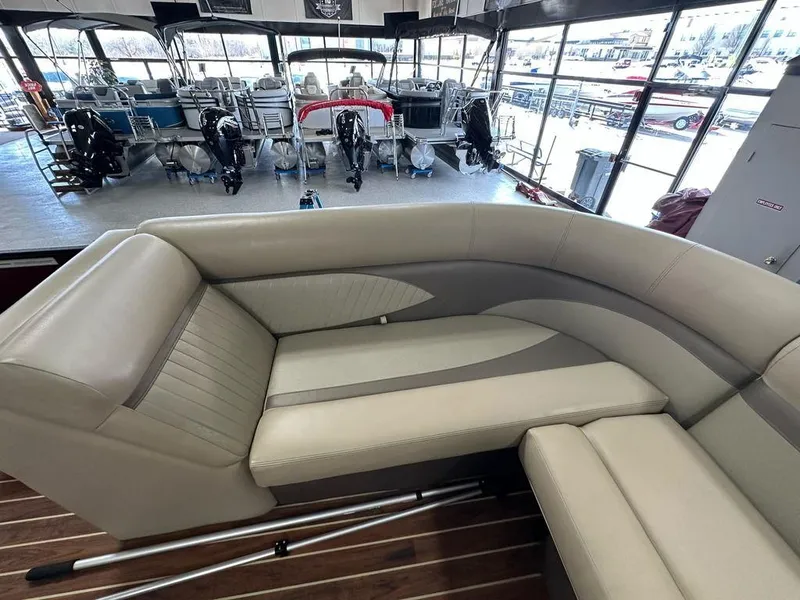 Slide: The Image of Luxurious seating on a 2018 Crest Classic 230 SLC pontoon boat in a showroom. - 6