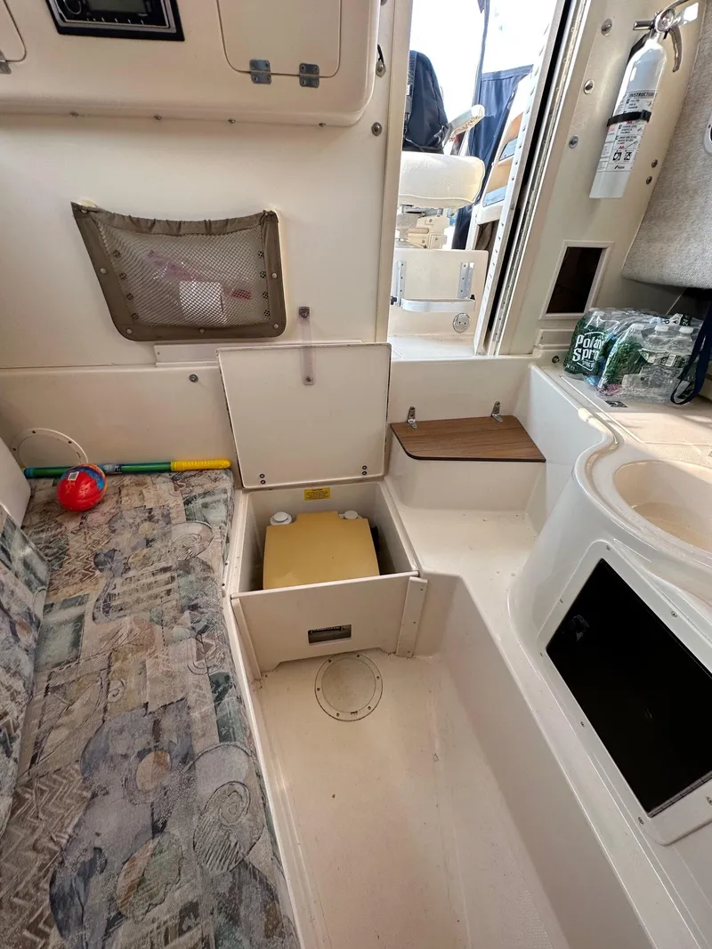 Slide: The Image of Interior of 2002 Grady-White Gulfstream 232 boat with storage compartments and seating area. - 3