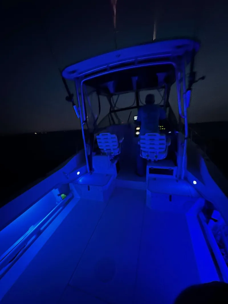 Slide: The Image of 2002 Grady-White Gulfstream 232 boat illuminated with blue lights at night. - 4