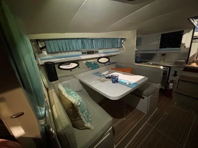 Slide: The Image of Interior of 1998 Wellcraft 3200 ST. Tropez boat with cozy dining area and cushions. - 10