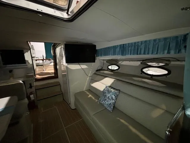 Slide: The Image of Interior of 1998 Wellcraft 3200 ST. Tropez yacht with sofa, TV, and portholes. - 11