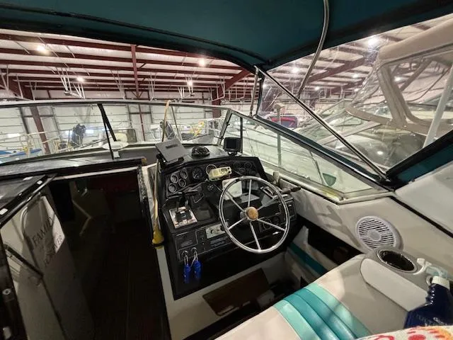 Slide: The Image of Interior view of 1998 Wellcraft 3200 ST. Tropez boat cockpit with steering wheel and controls. - 3