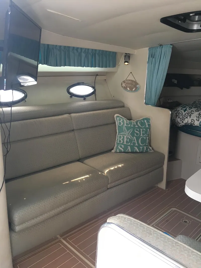Slide: The Image of Interior of a 1998 Wellcraft 3200 ST. Tropez boat with cozy seating and nautical decor. - 7