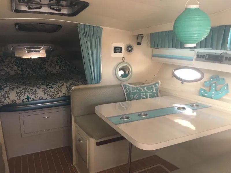 Slide: The Image of 1998 Wellcraft 3200 ST. TROPEZ cabin interior with dining area and cozy sleeping quarters. - 9