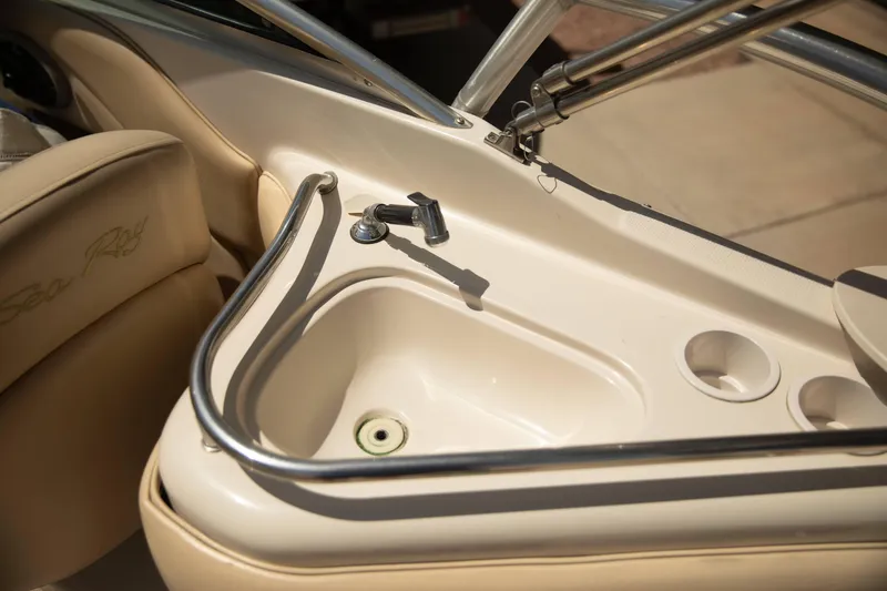 Slide: The Image of 2002 Sea Ray 240 Sundeck boat sink with faucet and cup holders. - 10