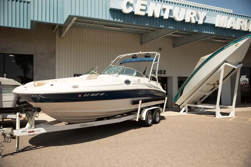 Slide: The Image of 2002 Sea Ray 240 Sundeck boat on trailer outside Century Marine dealership. - 2