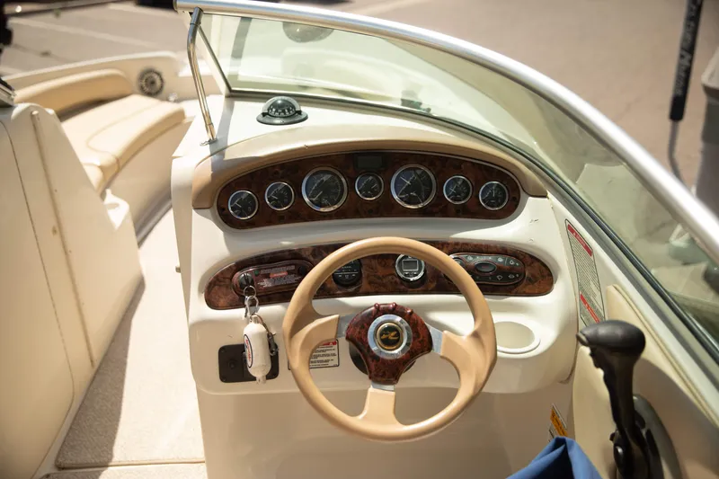 Slide: The Image of 2002 Sea Ray 240 Sundeck boat dashboard with steering wheel and instrument panel. - 6