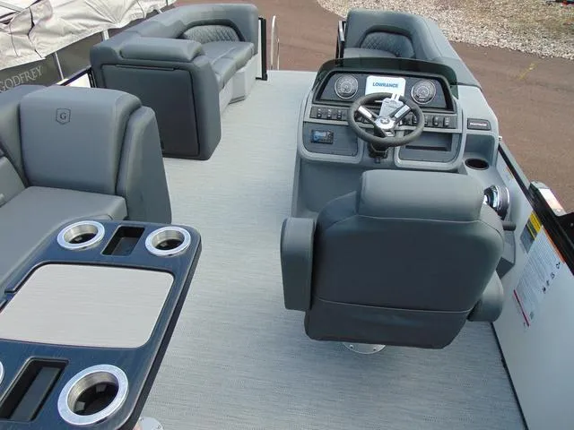 Slide: The Image of 2025 Godfrey Pontoons Sweetwater 2086 C interior with helm, seating, and cup holders. - 11