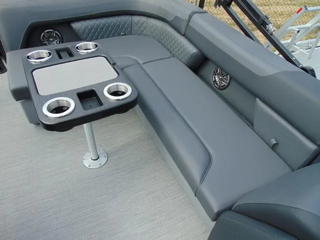 Slide: The Image of 2025 Godfrey Pontoons Sweetwater 2086 C interior with gray seating and table with cup holders. - 7
