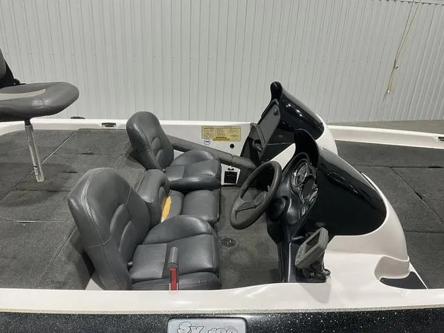 Slide: The Image of 2004 Skeeter SX190 boat interior with dual seats and steering console. - 10