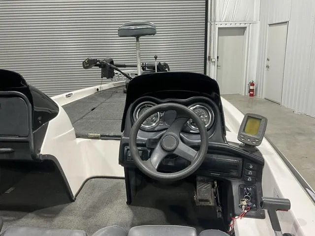 Slide: The Image of 2004 Skeeter SX190 boat interior with steering wheel and fish finder. - 11