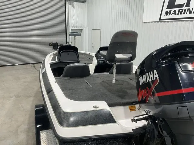 Slide: The Image of 2004 Skeeter SX190 boat with Yamaha engine in a garage setting. - 12