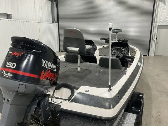 Slide: The Image of 2004 Skeeter SX190 boat with Yamaha VMAX 150 engine in a garage setting. - 13