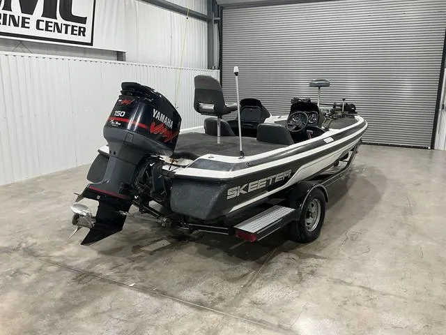 Slide: The Image of 2004 Skeeter SX190 boat with Yamaha engine in a garage setting. - 8