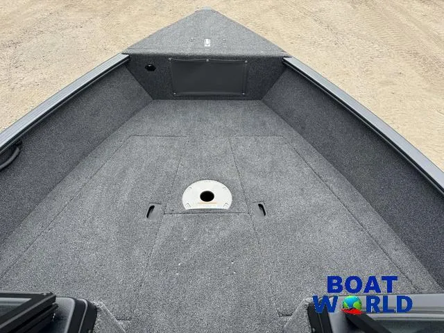 Slide: The Image of 2021 Lund 1675 Adventure Sport boat interior with gray carpet and storage compartment. - 12