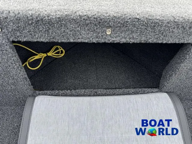 Slide: The Image of 2021 Lund 1675 Adventure Sport boat interior storage compartment with yellow rope, Boat World logo. - 16