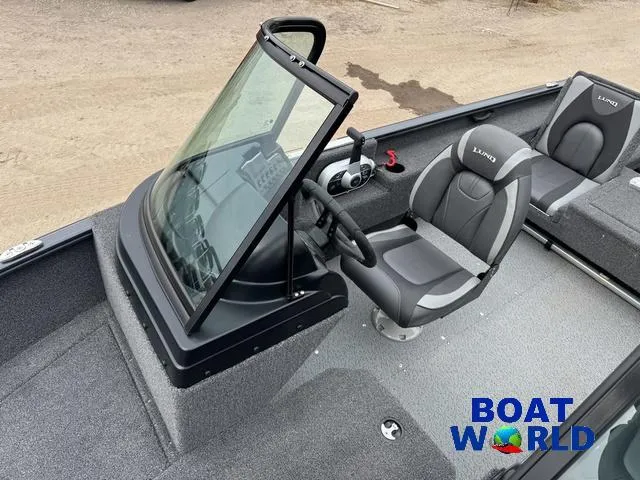 Slide: The Image of 2021 Lund 1675 Adventure Sport boat interior with steering console and seating, Boat World logo. - 22