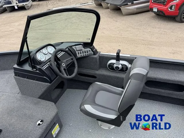 Slide: The Image of 2021 Lund 1675 Adventure Sport boat interior with steering wheel and dashboard controls. - 25