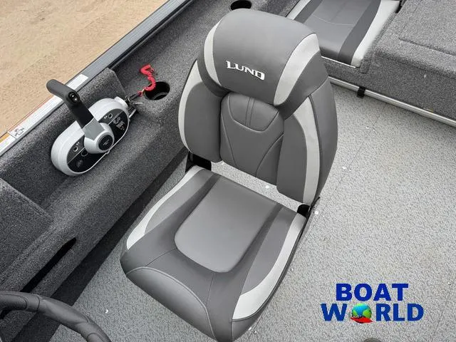 Slide: The Image of 2021 Lund 1675 Adventure Sport boat seat with control panel, gray upholstery, and "Boat World" logo. - 26