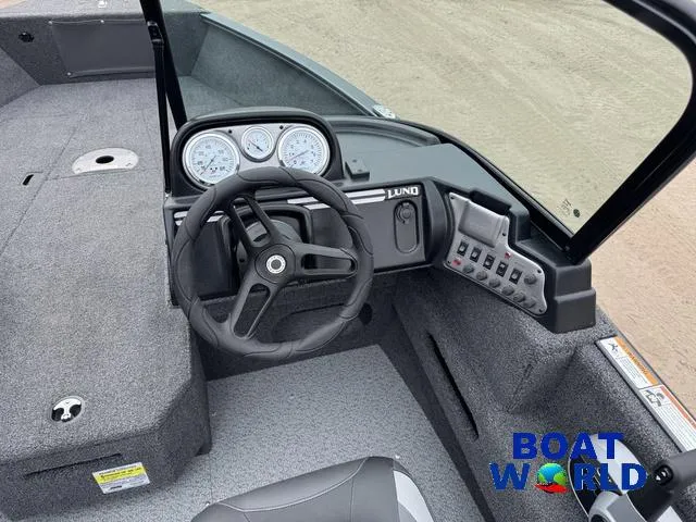 Slide: The Image of 2021 Lund 1675 Adventure Sport boat interior with steering wheel and dashboard controls. - 27