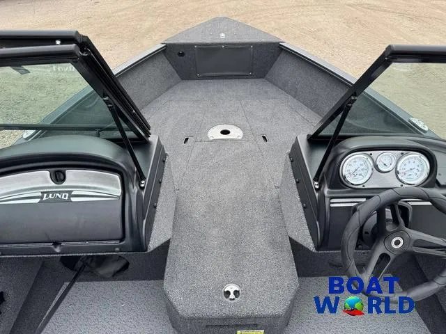 Slide: The Image of 2021 Lund 1675 Adventure Sport boat interior with dashboard and steering wheel, displayed at Boat World. - 3