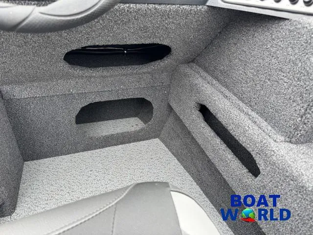 Slide: The Image of 2021 Lund 1675 Adventure Sport interior with gray carpet and storage compartments. - 31