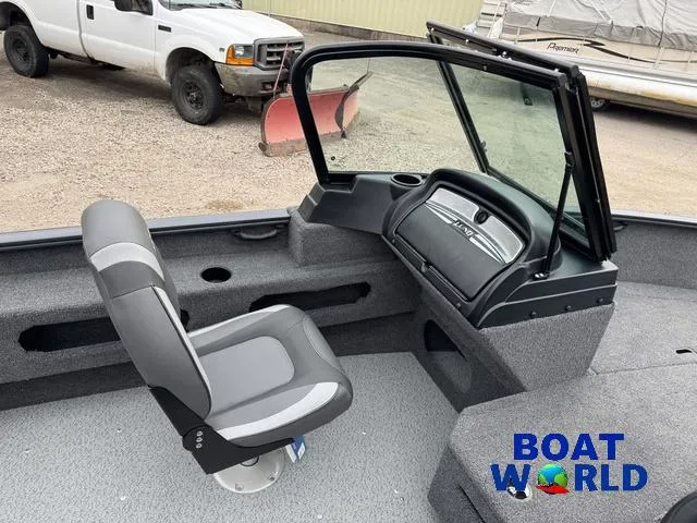 Slide: The Image of 2021 Lund 1675 Adventure Sport boat interior with seating and dashboard, displayed at Boat World. - 34