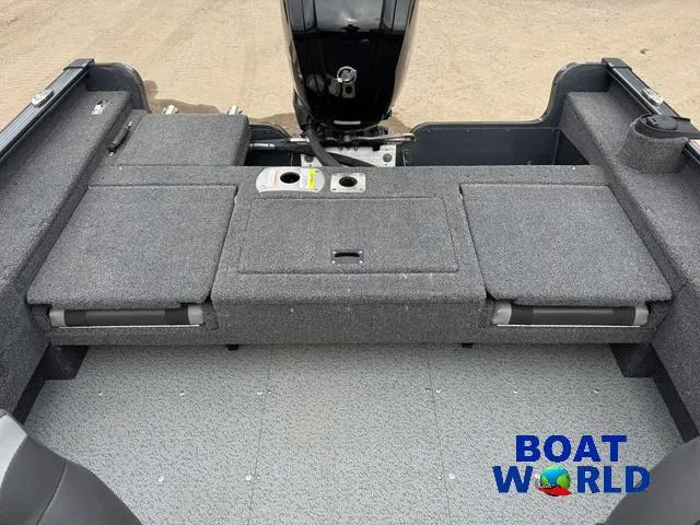 Slide: The Image of 2021 Lund 1675 Adventure Sport boat interior with gray seating and storage compartments. - 8