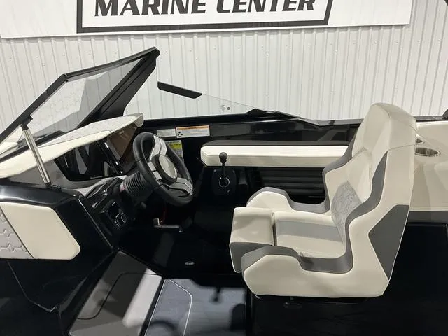 Slide: The Image of 2022 Heyday H22 boat interior with steering wheel and seating at a marine center. - 10
