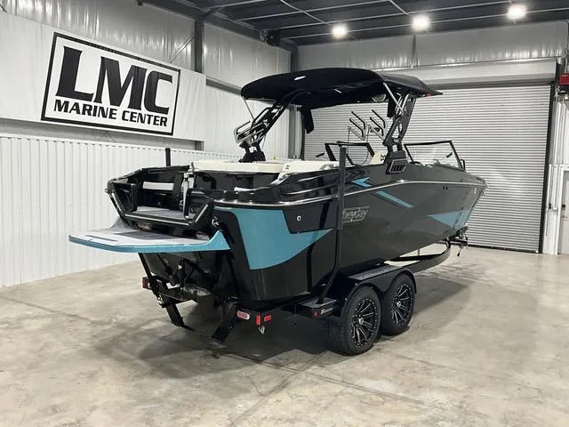 Slide: The Image of 2022 Heyday H22 boat in showroom, black and blue design, on trailer at LMC Marine Center. - 7