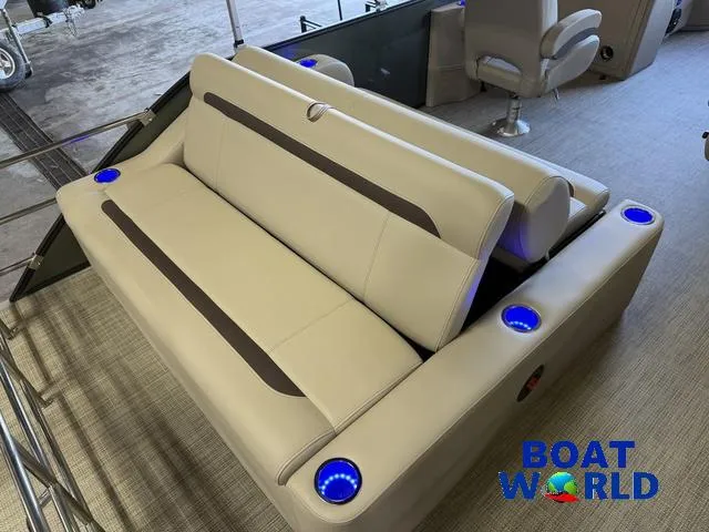 Slide: The Image of 2025 Bentley Pontoons Legacy 220 Swingback interior with beige seating and blue LED cup holders. - 19