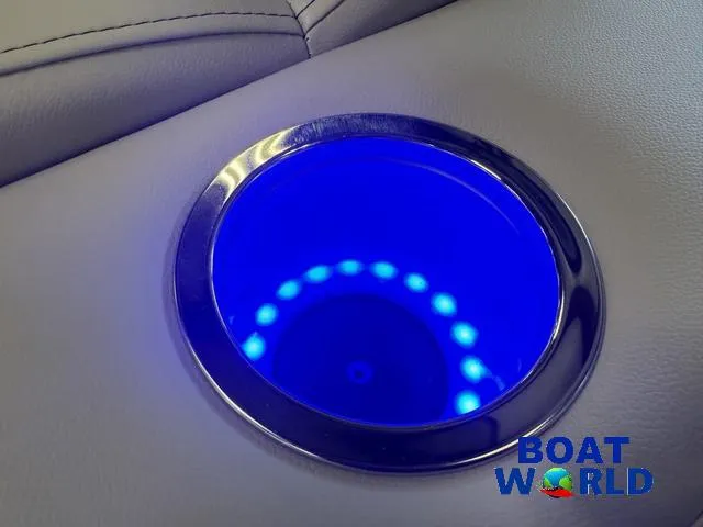 Slide: The Image of Illuminated cup holder on 2025 Bentley Pontoons Legacy 220 Swingback, featuring blue LED lights. - 24
