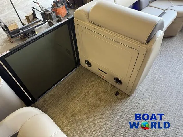 Slide: The Image of 2025 Bentley Pontoons Legacy 220 Swingback interior with beige seating and carpet, Boat World logo. - 26