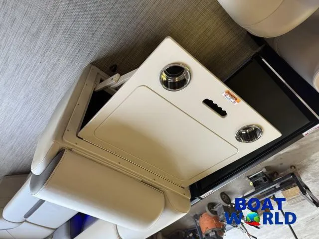 Slide: The Image of 2025 Bentley Pontoons Legacy 220 Swingback interior with storage compartment, featuring Boat World logo. - 27