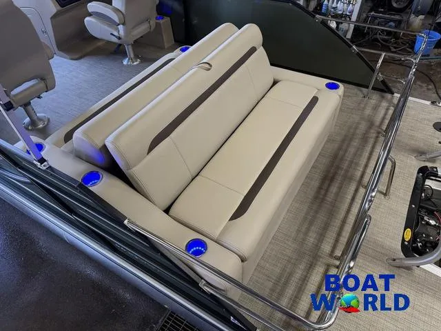 Slide: The Image of 2025 Bentley Pontoons Legacy 220 Swingback interior with beige seating and blue LED cup holders. - 5