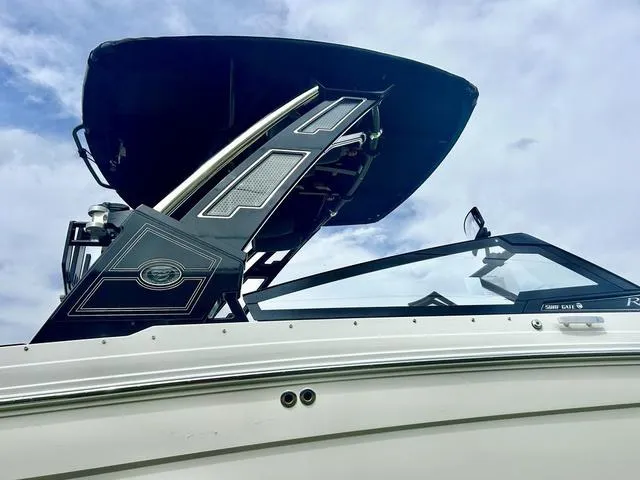 Slide: The Image of 2023 Cobalt R6 Surf boat with sleek design and modern features against a cloudy sky. - 10