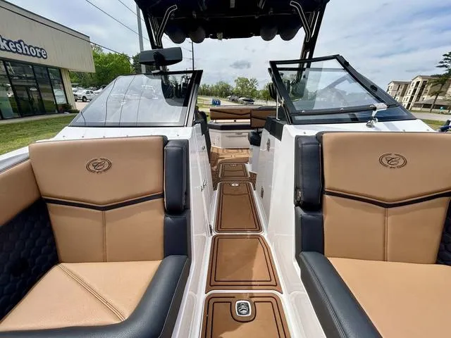 Slide: The Image of 2023 Cobalt R6 Surf boat interior with tan and black seating, open deck view. - 15