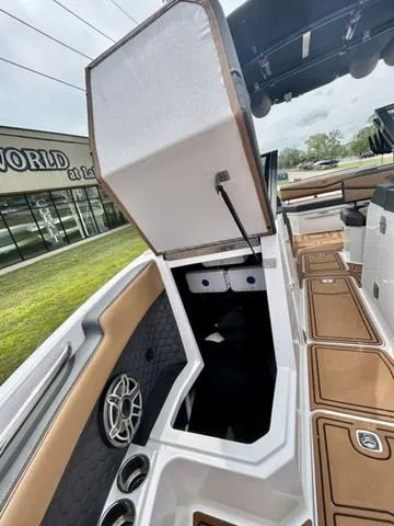 Slide: The Image of 2023 Cobalt R6 Surf boat interior with open storage compartment and seating area. - 18