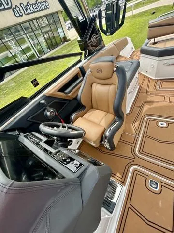 Slide: The Image of 2023 Cobalt R6 Surf boat interior with luxurious seating and modern dashboard. - 22