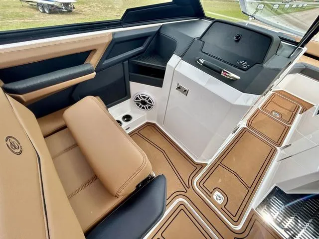 Slide: The Image of 2023 Cobalt R6 Surf boat interior with tan seating and modern dashboard design. - 26