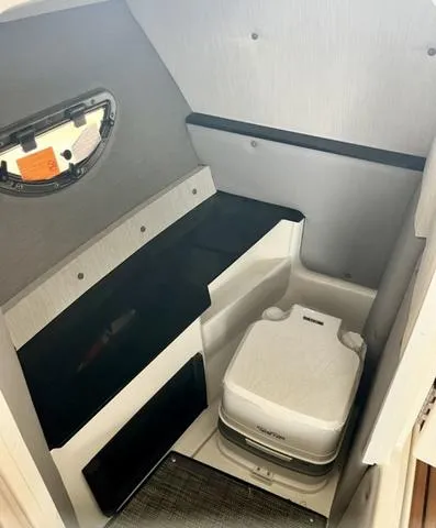 Slide: The Image of 2023 Cobalt R6 Surf interior cabin with compact portable toilet. - 28