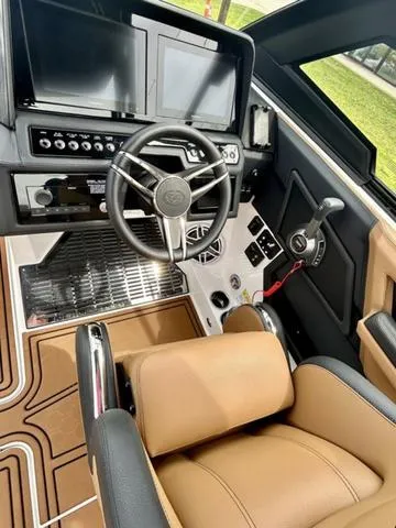 Slide: The Image of 2023 Cobalt R6 Surf boat cockpit with modern controls and tan seating. - 32